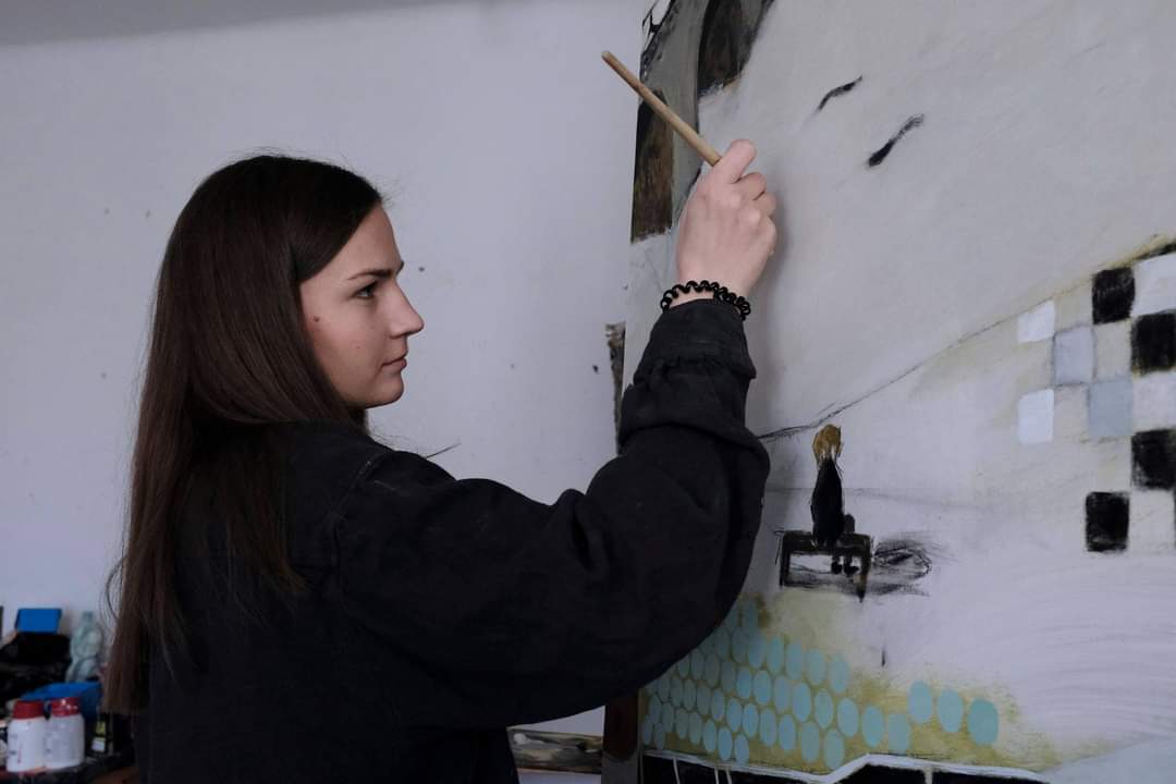 Barbara Mączka painting in her studio